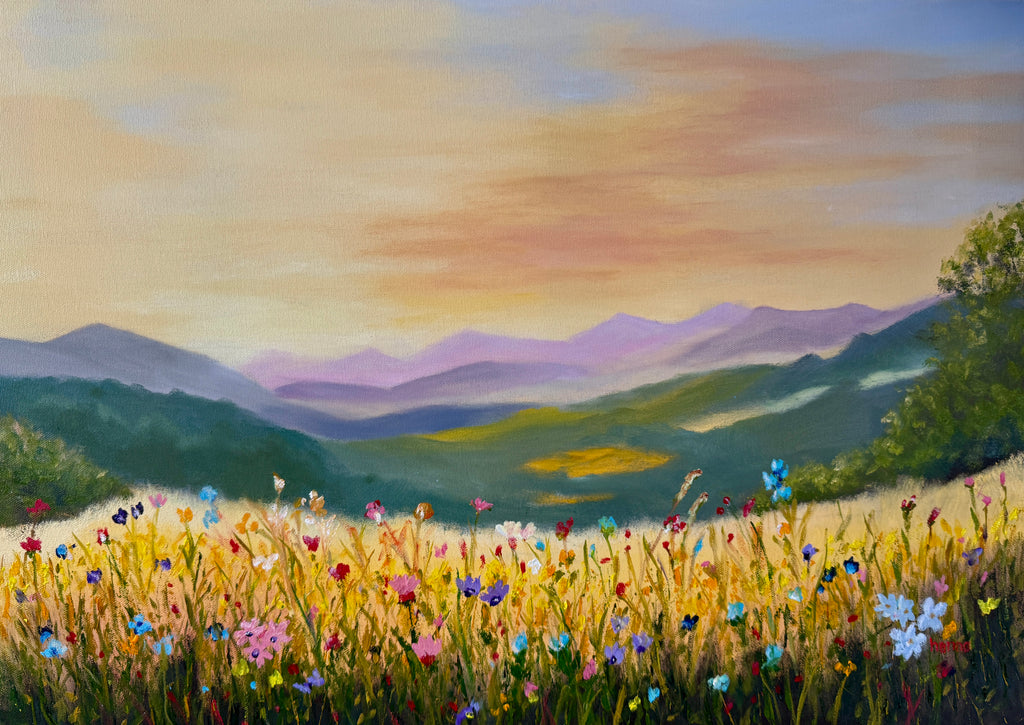 A landscape painting of a wildflower meadow in the foreground, with layered purple and green mountains in the distance under a warm yellow and blue sky.