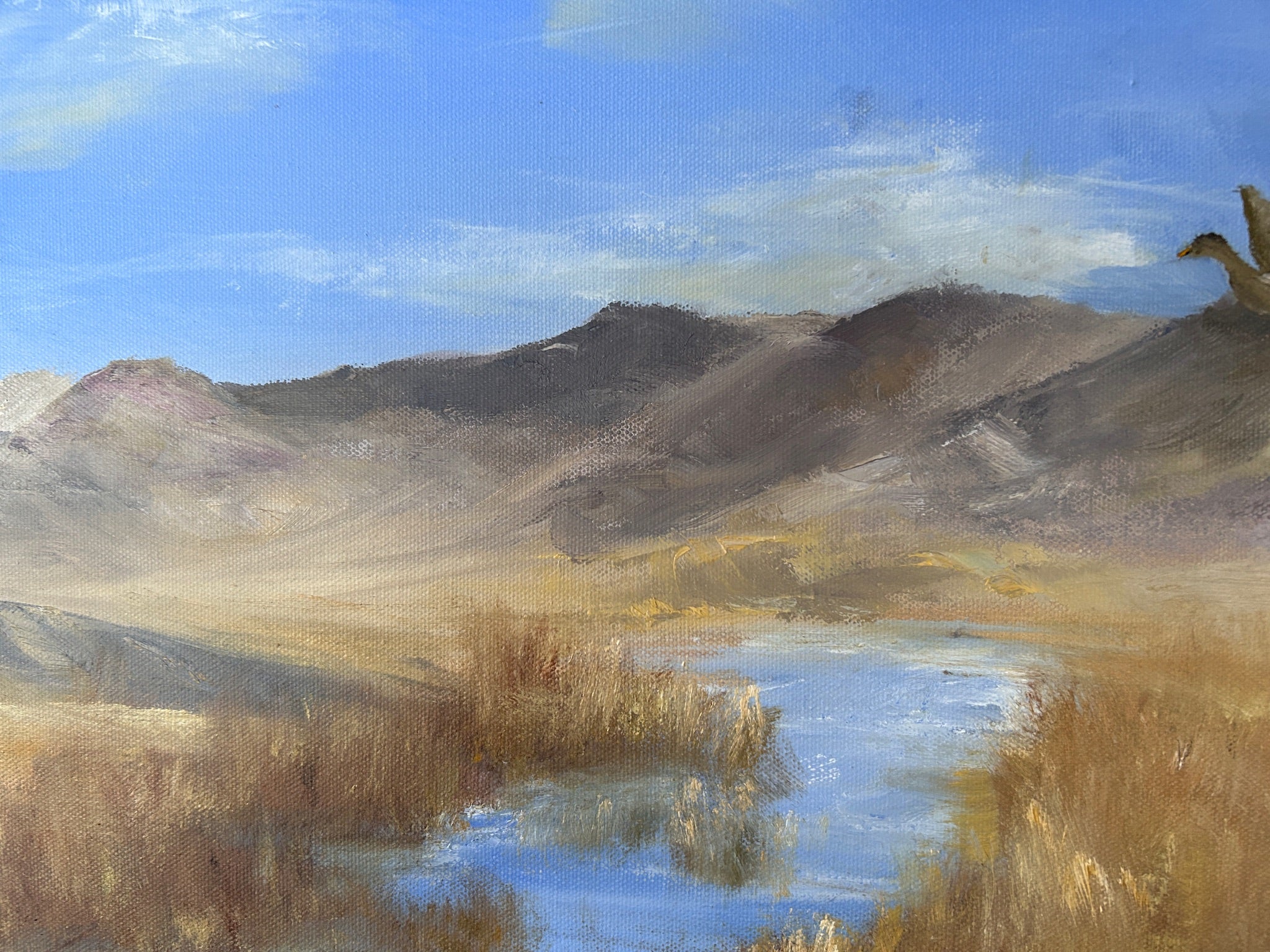 Painting of a landscape with mountains, water, and reeds under a blue sky.